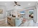 Comfortable living room with stylish furnishings, a mounted TV, and open access to the bedroom area at 145 Baytree Dr, Rotonda West, FL 33947