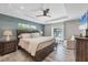 Comfortable main bedroom with tray ceilings, an ensuite bathroom, and serene views of the pool at 145 Baytree Dr, Rotonda West, FL 33947