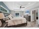 Inviting main bedroom featuring tray ceilings, an ensuite bathroom, and views of the pool at 145 Baytree Dr, Rotonda West, FL 33947