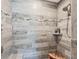 Tiled walk-in shower features sleek design and a convenient built-in bench at 145 Baytree Dr, Rotonda West, FL 33947