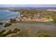 Stunning aerial view of waterfront condos surrounded by lush greenery and sparkling waters at 1610 Treehouse Cir # T130, Sarasota, FL 34231