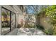 Private back patio area surrounded by lush greenery, providing a peaceful outdoor space at 1610 Treehouse Cir # T130, Sarasota, FL 34231