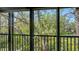 Balcony featuring serene nature views with lush greenery and mature trees through large glass doors at 1610 Treehouse Cir # T130, Sarasota, FL 34231