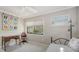 Light-filled bedroom with a window view, desk, and daybed providing a comfortable and functional space at 1610 Treehouse Cir # T130, Sarasota, FL 34231