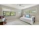 Well-lit bedroom with a desk, daybed, and multiple windows with views of mature trees at 1610 Treehouse Cir # T130, Sarasota, FL 34231