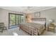 Comfortable bedroom featuring a large bed, and sliding glass doors leading to a balcony at 1610 Treehouse Cir # T130, Sarasota, FL 34231
