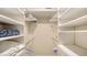 Bright walk-in closet with custom white shelving and drawers for optimal organization and storage at 1610 Treehouse Cir # T130, Sarasota, FL 34231