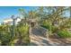 Charming clubhouse entrance featuring a covered walkway and lush landscaping at 1610 Treehouse Cir # T130, Sarasota, FL 34231