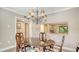 Traditional dining room showcasing a wood table beneath a decorative chandelier, adjacent to the updated kitchen at 1610 Treehouse Cir # T130, Sarasota, FL 34231