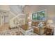 Cozy living room with a comfortable sofa, armchairs, and a large window overlooking the trees at 1610 Treehouse Cir # T130, Sarasota, FL 34231