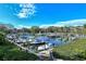 Picturesque marina with boats docked along wooden piers, surrounded by lush greenery under a blue sky at 1610 Treehouse Cir # T130, Sarasota, FL 34231