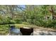 Outdoor patio space surrounded by lush, mature greenery at 1610 Treehouse Cir # T130, Sarasota, FL 34231