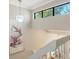Bright entryway with a white staircase and artistic accents on the wall at 1610 Treehouse Cir # T130, Sarasota, FL 34231
