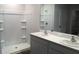 Bathroom with double vanity, framed mirror, and a tiled walk-in shower at 17060 James Trl, Parrish, FL 34219