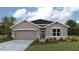 Charming single-Gathering home with a well-manicured lawn, paved driveway, and attached two-car garage at 17060 James Trl, Parrish, FL 34219
