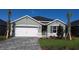 Charming single-Gathering home featuring a two-car garage, paved driveway, and well-manicured lawn at 17060 James Trl, Parrish, FL 34219