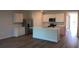 Modern kitchen with white cabinets, stainless steel appliances, and a central island at 17060 James Trl, Parrish, FL 34219