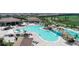 Aerial view of the community pool and recreational area with a waterfall, pool-side bar, and plenty of seating at 17604 Hickok Belt Loop, Bradenton, FL 34211
