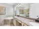 Bathroom with double sinks, vanity, soaking tub, and a frameless glass shower enclosure at 17604 Hickok Belt Loop, Bradenton, FL 34211