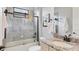 Updated bathroom features a tub with shower, granite vanity with a large framed mirror, and tiled walls at 17604 Hickok Belt Loop, Bradenton, FL 34211
