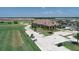 Aerial view of the clubhouse featuring a golf course, driving range, and parking for golf carts at 17604 Hickok Belt Loop, Bradenton, FL 34211