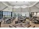 Spacious dining room with elegant table settings, large windows, and a scenic view of the golf course at 17604 Hickok Belt Loop, Bradenton, FL 34211