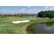 Scenic view of the golf course with a sand trap and water hazard, surrounded by lush greenery at 17604 Hickok Belt Loop, Bradenton, FL 34211