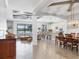Open-concept living space with modern furnishings, a lake view, and combined dining area at 17604 Hickok Belt Loop, Bradenton, FL 34211