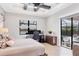 Main bedroom features a tray ceiling, desk, and sliding glass doors to the pool area at 17604 Hickok Belt Loop, Bradenton, FL 34211