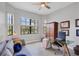 Bright home office with multiple windows, desk and seating area with decorative pillows, plus a closet for storage at 17604 Hickok Belt Loop, Bradenton, FL 34211