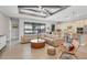 Open-concept area featuring a living room, kitchen with island, and dining area with lake views at 17604 Hickok Belt Loop, Bradenton, FL 34211