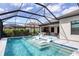 Gorgeous screened-in pool and spa with built-in loungers, and a large outdoor kitchen and entertaining area at 17604 Hickok Belt Loop, Bradenton, FL 34211