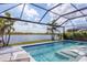 Stunning screened-in pool overlooking the water, featuring built-in loungers and a connected spa at 17604 Hickok Belt Loop, Bradenton, FL 34211