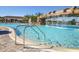 Community pool featuring a waterfall and poolside lounge chairs for relaxing in the sun at 17604 Hickok Belt Loop, Bradenton, FL 34211