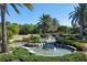 Picturesque water feature with multiple waterfalls, lush landscaping, and a serene atmosphere within the community at 17604 Hickok Belt Loop, Bradenton, FL 34211