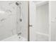 Modern bathroom featuring white marble tiling, updated fixtures, and a shower with glass door at 203 22Nd Ne St, Bradenton, FL 34208