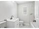 Modern bathroom featuring white marble tiling, updated fixtures, and a window providing natural light at 203 22Nd Ne St, Bradenton, FL 34208