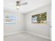 Bright bedroom with tile floors, neutral paint, large windows and ceiling fan at 203 22Nd Ne St, Bradenton, FL 34208