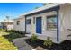 Charming single-story home featuring a freshly painted exterior, blue door, and well-maintained landscaping at 203 22Nd Ne St, Bradenton, FL 34208