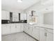 Stylish kitchen featuring white cabinetry, modern appliances, and attractive backsplash at 203 22Nd Ne St, Bradenton, FL 34208