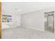 Bright living room features neutral paint, tile floors, base molding and large window at 203 22Nd Ne St, Bradenton, FL 34208