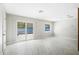 Bright living area featuring tile floors, recessed lighting, and sliding glass doors to the backyard at 203 22Nd Ne St, Bradenton, FL 34208