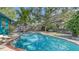 Home's serene pool features well-maintained landscaping and trees, ensuring a private and refreshing retreat at 2261 Linwood Dr, Sarasota, FL 34232