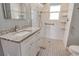 Accessible bathroom featuring granite vanity, roll-in shower, and support bars at 2332 Canalbluff Pl # 298, Sarasota, FL 34231