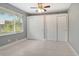 Spacious bedroom featuring two large closets and a large window to the yard at 2332 Canalbluff Pl # 298, Sarasota, FL 34231