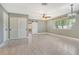 Bright bedroom featuring a ceiling fan, two closets, and a view to the yard at 2332 Canalbluff Pl # 298, Sarasota, FL 34231