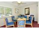 Bright dining room featuring a glass table, six chairs and view from the window at 2332 Canalbluff Pl # 298, Sarasota, FL 34231