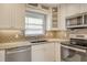 Well-lit kitchen boasts stainless steel appliances, granite counters and an attractive tile backsplash at 2332 Canalbluff Pl # 298, Sarasota, FL 34231