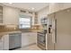 Contemporary kitchen with white cabinetry, stainless steel appliances, and granite countertops at 2332 Canalbluff Pl # 298, Sarasota, FL 34231