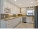 Modern kitchen featuring white cabinetry, stainless steel appliances, and stylish backsplash at 2332 Canalbluff Pl # 298, Sarasota, FL 34231
